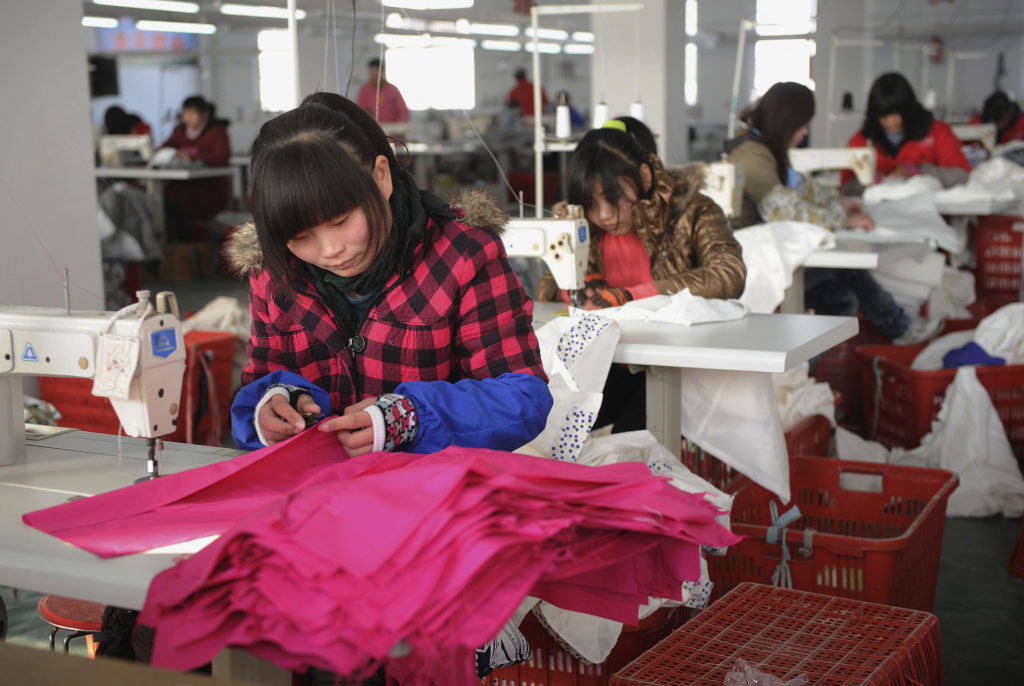 Employees work at a garment factory of Hefei Shichao Clothing Co. Ltd in Hefei, Anhui province January 16, 2011. The Trump...