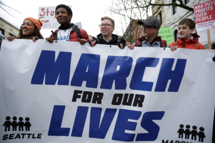High school students carry a banner during a "March for Our Lives" demonstration demanding gun control in Seattle, Washington, D.C. Photo by Jason Redmond/Reuters