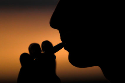 A young man smokes a Suorin Drop electronic cigarette in this picture illustration taken September 14, 2018. Photo by Mike Blake/Illustration via Reuters