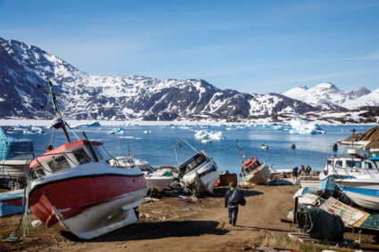 A man walks to his boat past a number of abandoned and dry-docked boats in the town of Tasiilaq, Greenland, June 15, 2018. Photo by Lucas Jackson/Reuters