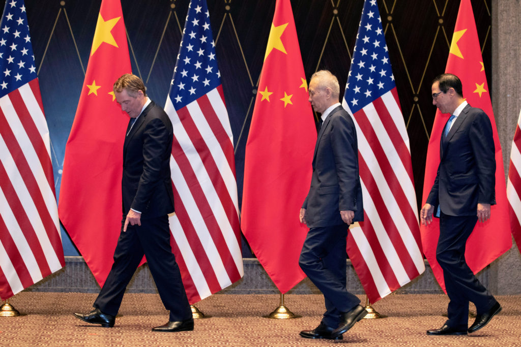 U.S. Trade Representative Robert Lighthizer points at markers on the floor as he leads Chinese Vice Premier Liu He and Tre...