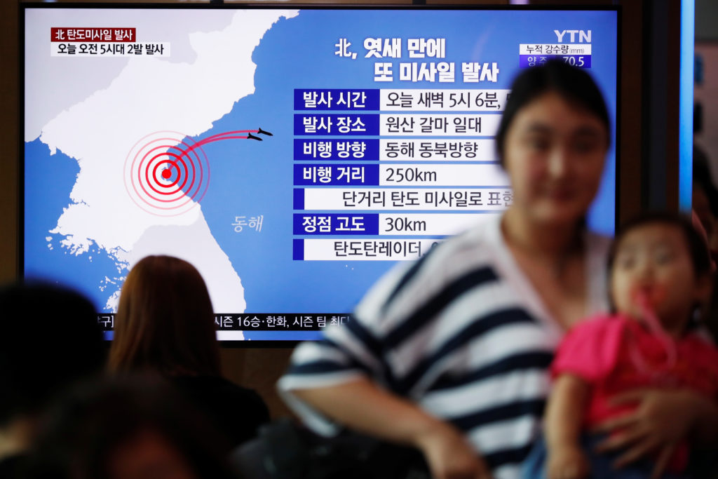 People watch a TV broadcast of a news report on North Korea firing short-range ballistic missiles, in Seoul, South Korea, ...
