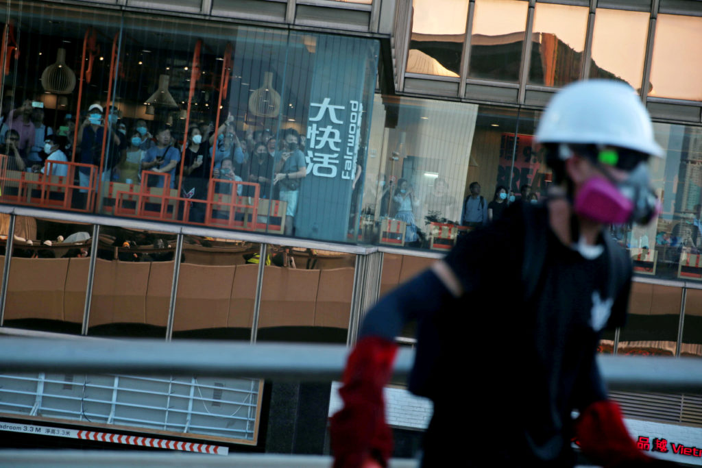 Restaurant customers watch from a window as demonstrators clash with Hong Kong police in Hardcourt Road, Admiralty, in Hon...