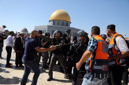 The Dome of the Rock is seen in the background as Israeli police clash with Palestinian worshippers on the compound known to Muslims as Noble Sanctuary and to Jews as Temple Mount as Muslims mark Eid al-Adha, in Jerusalem's Old City on August 11, 2019. Photo by Ammar Awad/Reuters