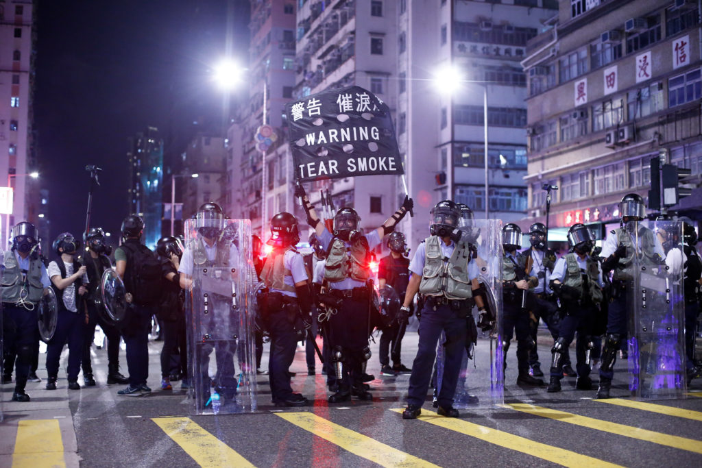 Police stand at a junction in the Sham Shui Po neighbourhood during clashes with anti-extradition bill protesters in Hong ...