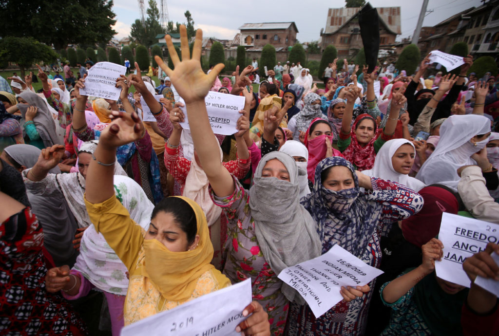 Kashmiri women shout slogans at a protest after Friday prayers during restrictions after the Indian government scrapped th...
