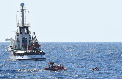 Migrants swim after jumping off the Spanish rescue ship Open Arms, close to the Italian shore in Lampedusa, Italy on August 20, 2019. Photo by Guglielmo Mangiapane/Reuters