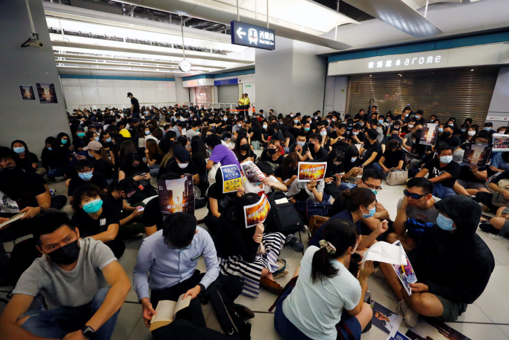People protest during a silent sit-in gathering at Yuen Long MTR station, the scene of an attack by suspected triad gang m...