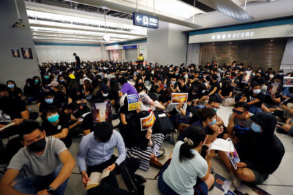 People protest during a silent sit-in gathering at Yuen Long MTR station, the scene of an attack by suspected triad gang members a month ago, in Yuen Long, New Territories, Hong Kong, China August 21, 2019. Photo by Kai Pfaffenbach/Reuters