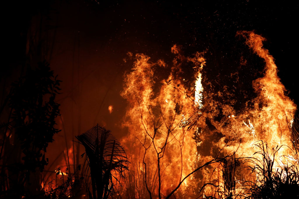 A fire burns a tract of Amazon jungle as it is cleared by loggers and farmers near Altamira, Brazil, August 27, 2019. Phot...