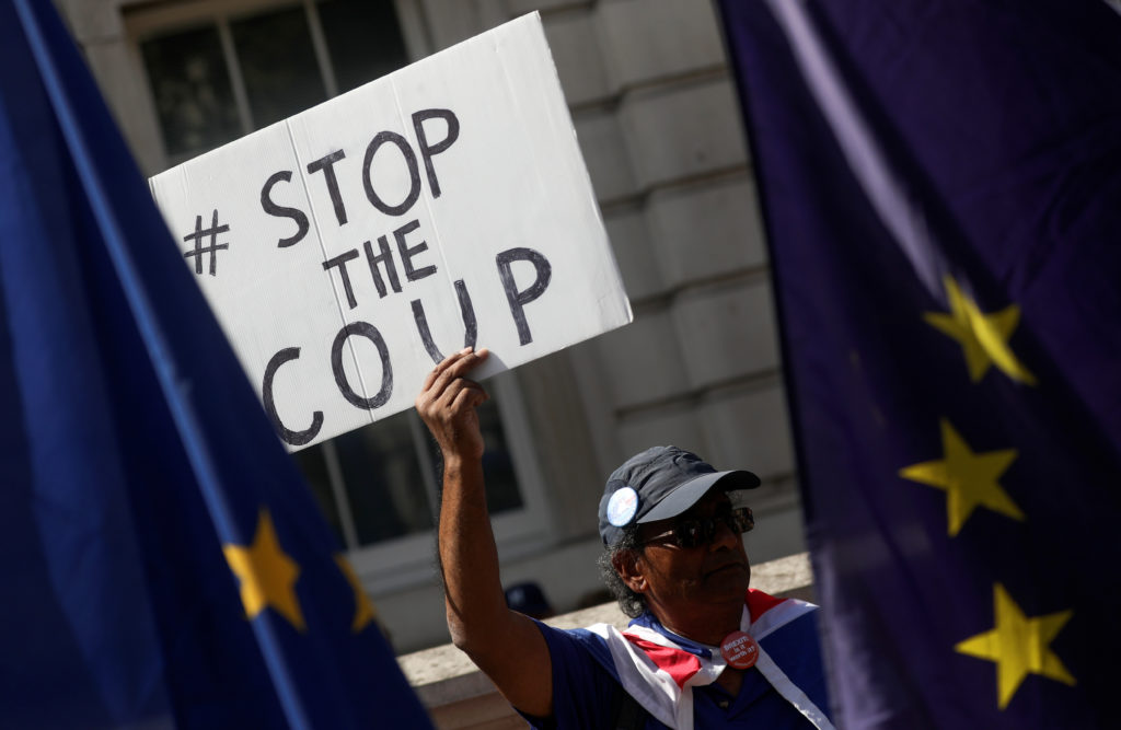 An anti-Brexit protester holds a placard as he demonstrates in Westminster in London, Britain on August 29, 2019. Photo by...