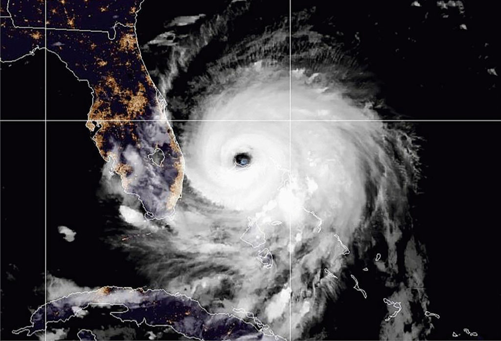 The eye of Hurricane Dorian remains near the city of Freeport, Bahamas in a satellite photograph distributed by the NOAA's...