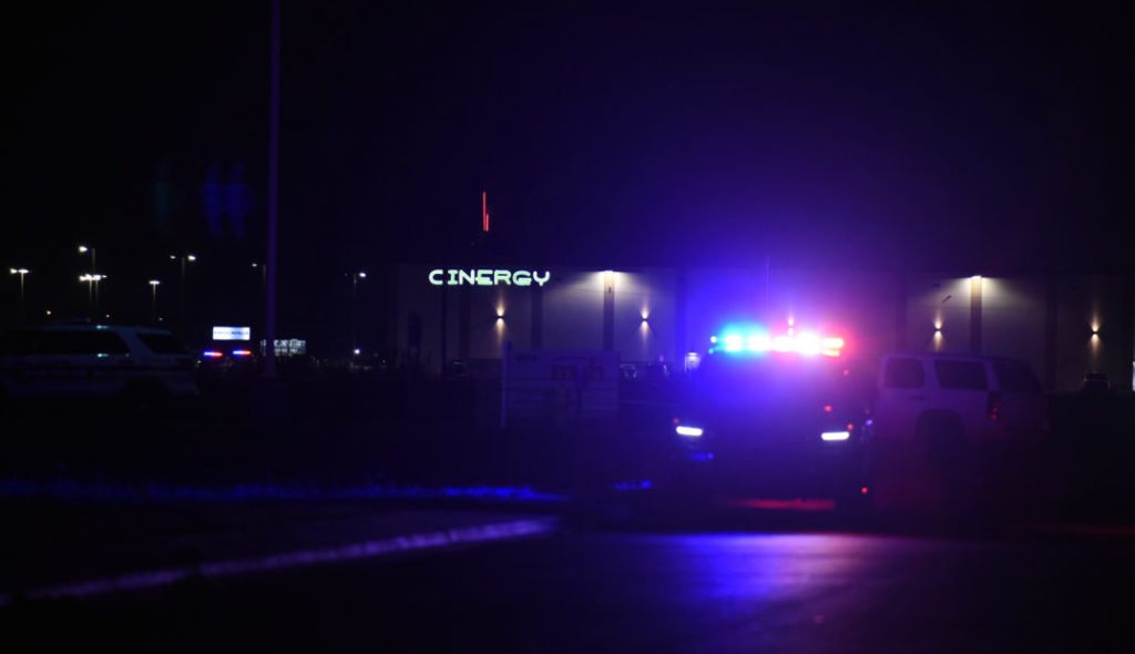 Police vehicles sit outside of Cinergy movie theater after a man went on a shooting spree in Odessa, Texas,on September 1,...