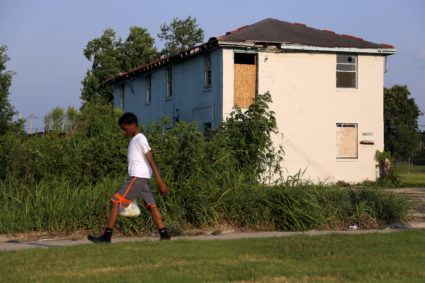 A young boy walks past an abandoned house in the Lower Ninth Ward neighborhood of New Orleans, Louisiana, July 31, 2015. The areas with the most income inequality last year included Louisiana, according to Census data. Photo by Jonathan Bachman/Reuters