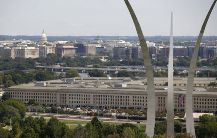 A U.S. flag is seen unfurled at the Pentagon between the spires of the Air Force Memorial during a 9/11 observance in Arlington, Virginia, in 2017. Photo by Joshua Roberts/Reuters