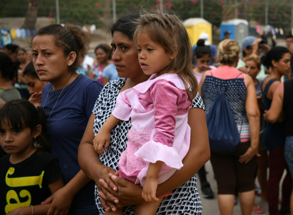 Migrants, many of whom are asylum seekers sent back to Mexico from the U.S. under Migrant Protection Protocols (MPP), line...