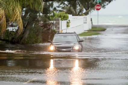 A car drives through a flooded street after the effects of Hurricane Dorian arrived in Nassau, Bahamas, September 2, 2019. Photo by John Marc Nutt /Reuters