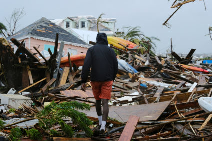 A man walks through the rubble in the aftermath of Hurricane Dorian on the Great Abaco island town of Marsh Harbour, Bahamas, September 2, 2019. Picture taken September 2, 2019. Photo by Dante Carrer/Reuters