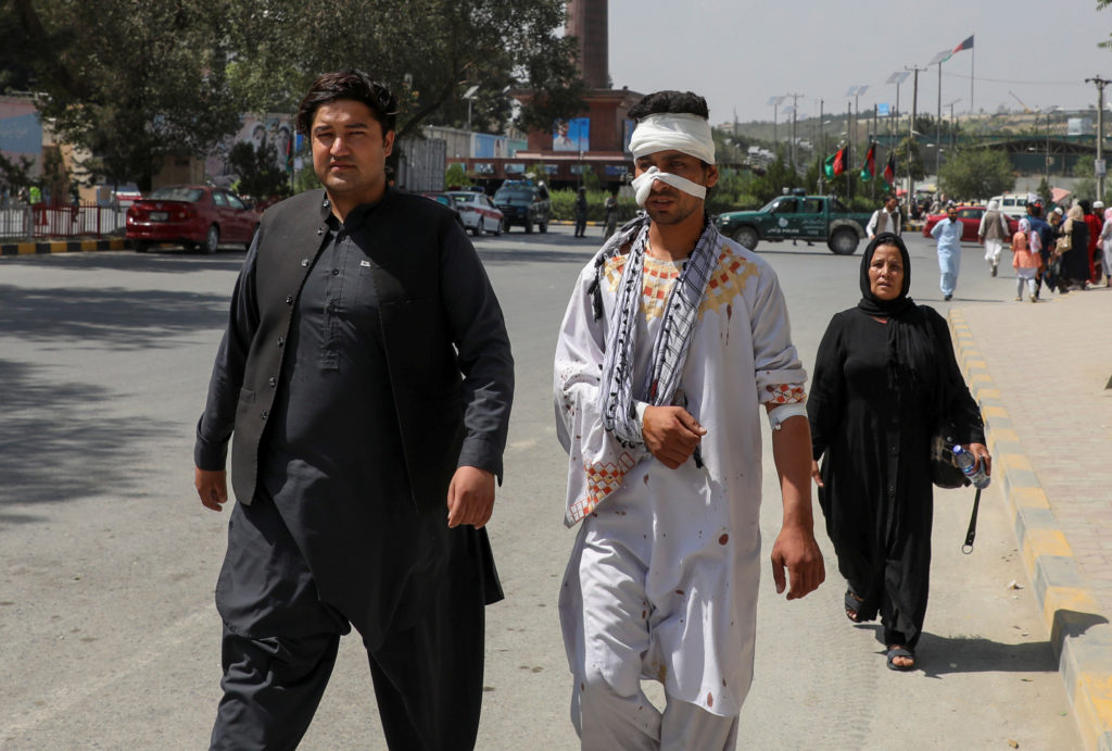A wounded man walks after receiving hospital treatment, near the site of a suicide attack in Kabul, Afghanistan September ...