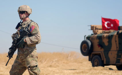 An American soldier walks near a Turkish military vehicle during a joint U.S.-Turkey patrol, near Tel Abyad, Syria September 8, 2019. Photo by Rodi Said/Reuters