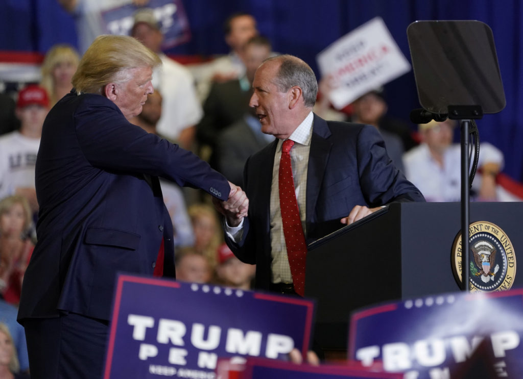 U.S. President Donald Trump shakes hands with Republican nominee Dan Bishop during a campaign rally in Fayetteville, North...