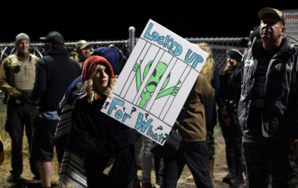 A woman carries a sign outside a gate to Area 51 as an influx of tourists responding to a call to 'storm' Area 51, a secretive U.S. military base believed by UFO enthusiasts to hold government secrets about extra-terrestrials, is expected in Rachel, Nevada, U.S. September 20, 2019. Photo by Jim Urquhart/Reuters