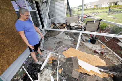 Cathy McCabe stands next to remnants of her damaged house after a tornado spawned by Hurricane Dorian ripped through Carolina Shores, North Carolina. Photo by Jonathan Drake/Reuters