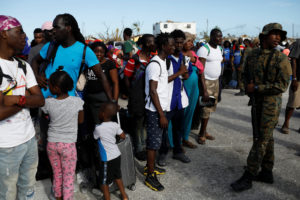 A soldier helps manage the crowd during an evacuation at Marsh Harbour Government Port after Hurricane Dorian hit the Abaco Islands in the Bahamas, September 6, 2019. Photo by Marco Bello/Reuters
