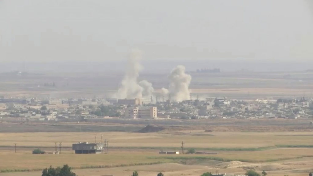 Smoke billows out after Turkish shelling on the Syrian border town of Ras Al Ain, as seen from Ceylanpinar, Turkey, Octobe...