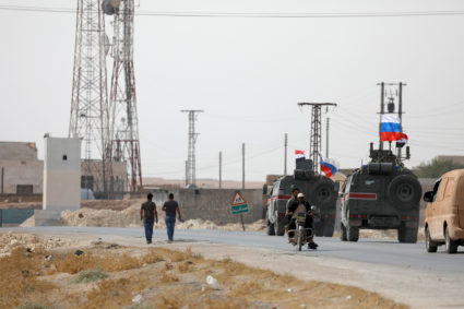 Russian and Syrian national flags flutter on military vehicles near Manbij, Syria October 15, 2019. Photo by Omar Sanadiki/Reuters