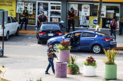 Cartel gunmen are seen outside during clashes with federal forces following the detention of Ovidio Guzman, son of drug kingpin Joaquin "El Chapo" Guzman, in Culiacan, Sinaloa state, Mexico October 17, 2019. Photo by Jesus Bustamante/Reuters