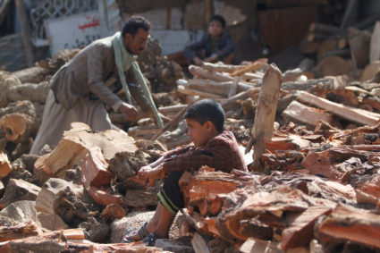 A boy sits between the wood poles at a market amid the ongoing fuel and cooking gas shortages in Sanaa, Yemen October 18, 2019. Photo by Mohamed al-Sayaghi/Reuters