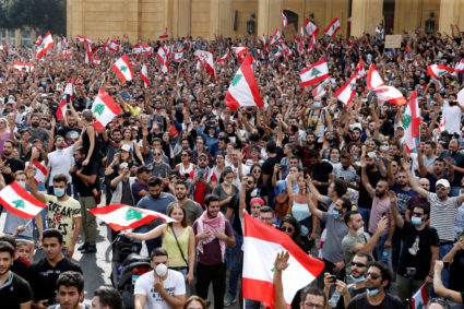 Demonstrators hold Lebanese flags as they gather during a protest over deteriorating economic situation, in Beirut, Lebanon October 18, 2019. Photo by Mohamed Azakir/Reuters