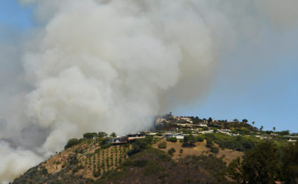 Firefighters battle a blaze from the air that was threatening homes in the Pacific Palisades community of Los Angeles, California, U.S., October 21, 2019. Photo by Gene Blevins/Reuters