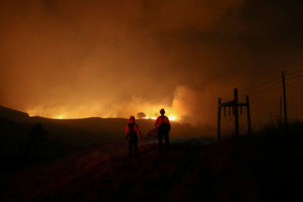 Two firefighters monitor the Kincade fire, near Geyserville, California, U.S. October 24, 2019. Photo by Stephen Lam/Reuters