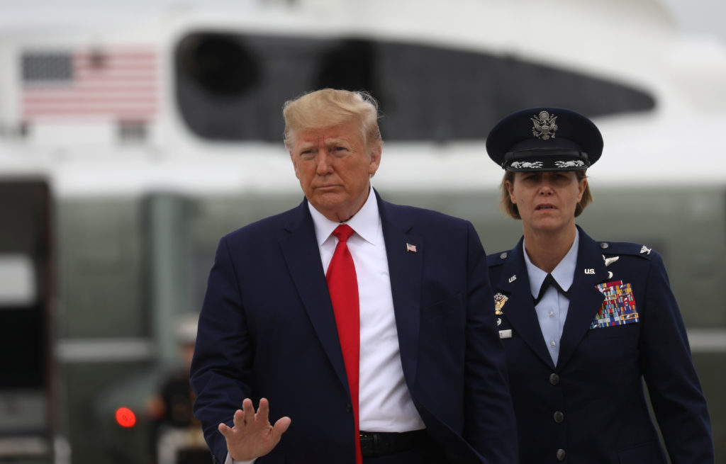 U.S. President Donald Trump waves to the news media as he boards Air Force One to depart for travel to South Carolina from...
