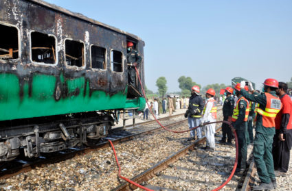 Firefighters and rescue workers gather near the place where a fire broke out in a passenger train and destroyed three carriages near the town of Rahim Yar Khan, Pakistan October 31, 2019. Photo via Reuters