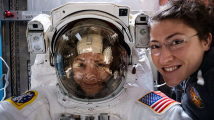 NASA astronaut Christina Koch (right) poses for a portrait with fellow Expedition 61 Flight Engineer Jessica Meir of NASA who is inside a U.S. spacesuit for a fit check. Photo and caption by NASA