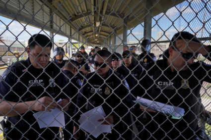 U.S. Customs and Border Protection agents call the names of asylum seekers that have a court hearing that day as a group of migrants, who returned to Mexico to await their U.S. asylum hearing, block the Puerta Mexico international border crossing bridge to demand a speedier asylum process in Matamoros, Mexico, October 10, 2019. Photo by Veronica G. Cardenas/Reuters