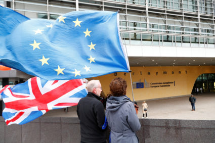 Anti-Brexit protesters hold British and European Union flags outside the EU Commission headquarters in Brussels, Belgium October 11, 2019. Photo by REUTERS/Francois Lenoir