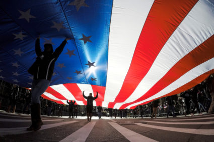 People carry the U.S. flag during the Veterans Day Parade in New York, U.S., November 11, 2017. REUTERS/Eduardo Munoz TPX IMAGES OF THE DAY