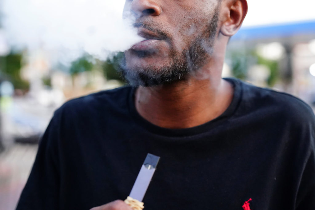 A man uses a Juul vaporizer in Atlanta, Georgia, U.S., September 26, 2019. Photo by Elijah Nouvelage/Reuters