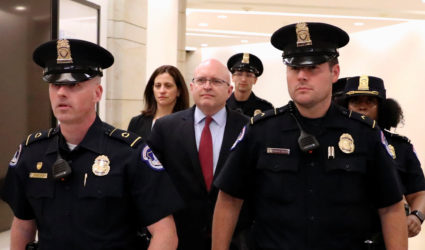 Philip Reeker, acting assistant secretary of state for European and Eurasian Affairs, is escorted by police officers as he leaves after testifying in impeachment inquiry against President Donald Trump, in Washington D.C. , U.S., October 26, 2019. Photo by Siphiwe Sibeko/Reuters