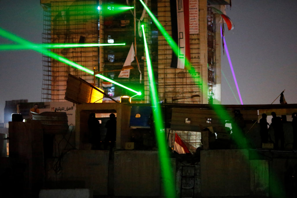 Iraqi demonstrators use laser during the ongoing anti-government protests in Baghdad, Iraq, November 6, 2019. REUTERS/Thai...