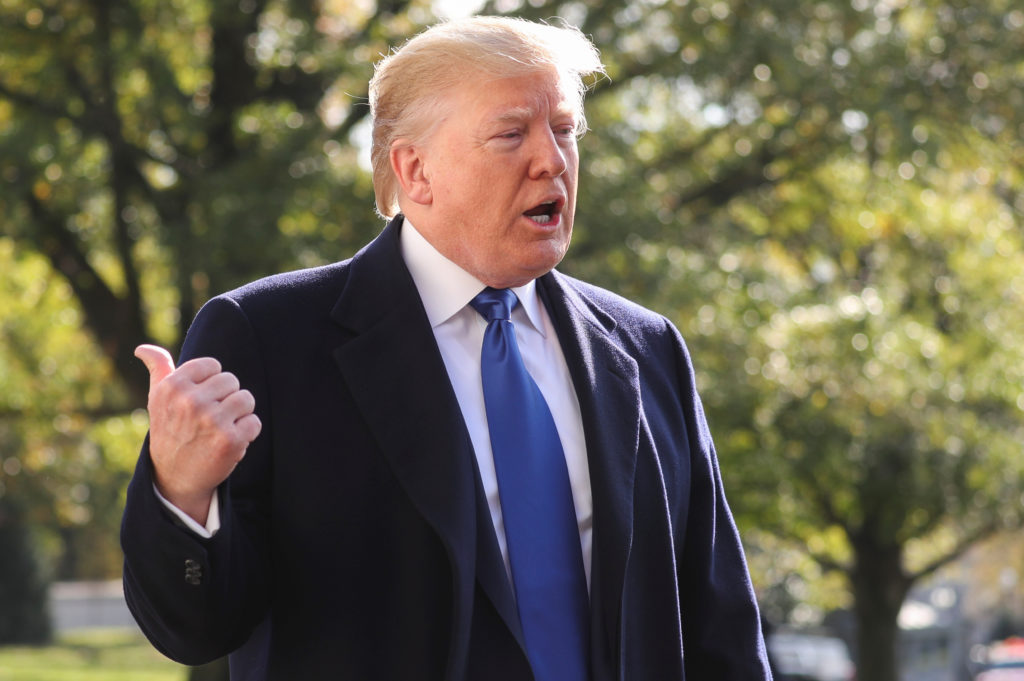 U.S. President Donald Trump talks to reporters as he departs for travel to Georgia from the South Lawn of the White House ...