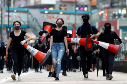 Protesters walk down the road with traffic cones to build a barricade in Causeway Bay, Hong Kong, China November 11, 2019. Photo by Thomas Peter/Reuters