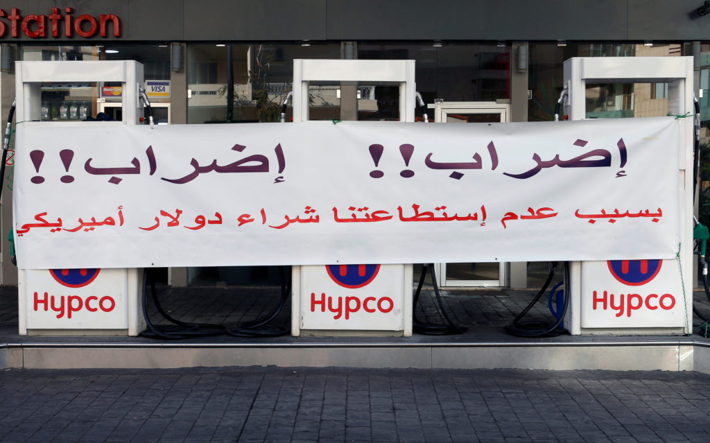 A banner is seen at a petrol station in Beirut, Lebanon on November 28, 2019. The banner reads: "Strike!! Strike!! Because...