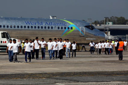 Guatemalan migrants walk on the tarmac after being deported from U.S., at La Aurora International airport in Guatemala City, Guatemala November 21, 2019. Photo by REUTERS/Luis Echeverria