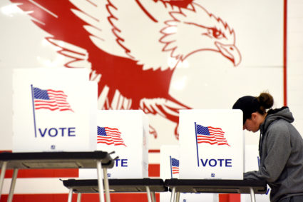 A voters fills out their ballot for the midterm election at a polling place in Madison, Wisconsin, U.S. November 6, 2018. Photo by REUTERS/Nick Oxford