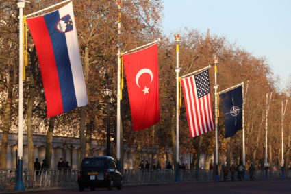London taxi drives past NATO and members' flags ahead of Nato Summit in London, Britain. Photo by Yves Herman/Reuters